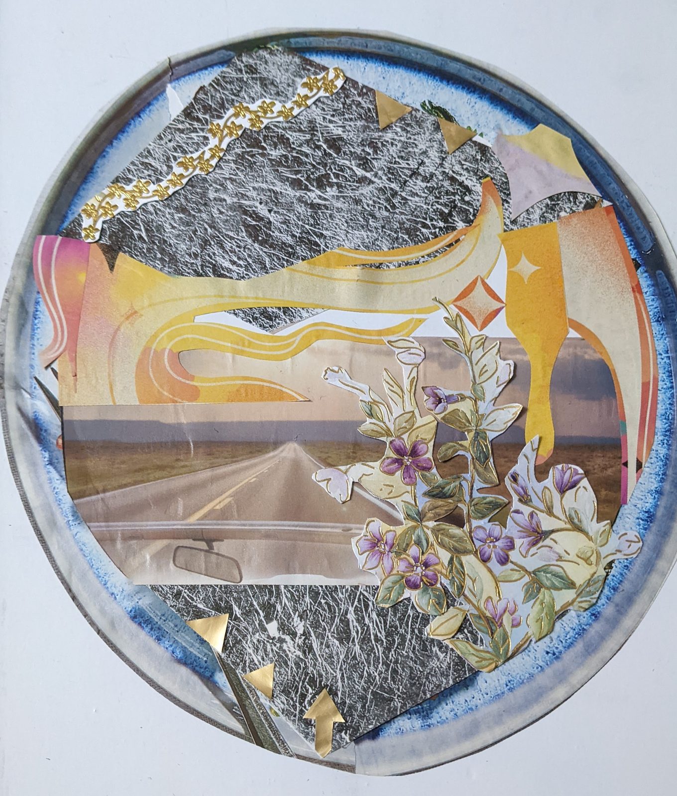 Round collage artwork made in art therapy, featuring a road, wildflowers, and a golden sunrise